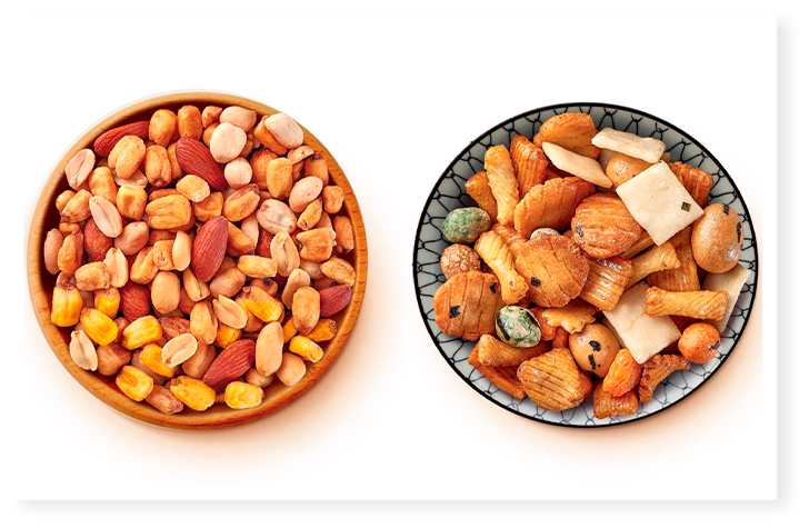 Menguys apéro avec deux bols de mélanges de noix et snacks salés.